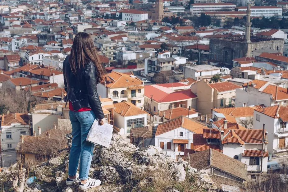 young-girl-standing-in-front-of-beautiful-city-vie-2025