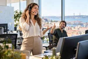 Young sales professional on a call in a modern Lisbon office overlooking the river